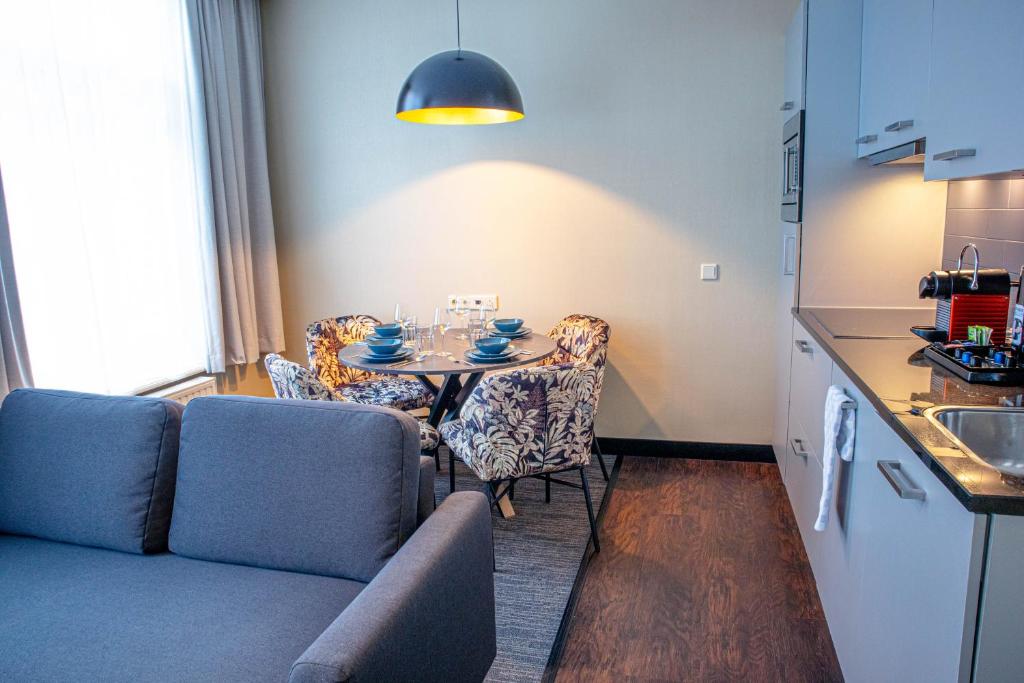 Superior apartment living room with sofa bed and kitchenette at Golden Mansion Amsterdam